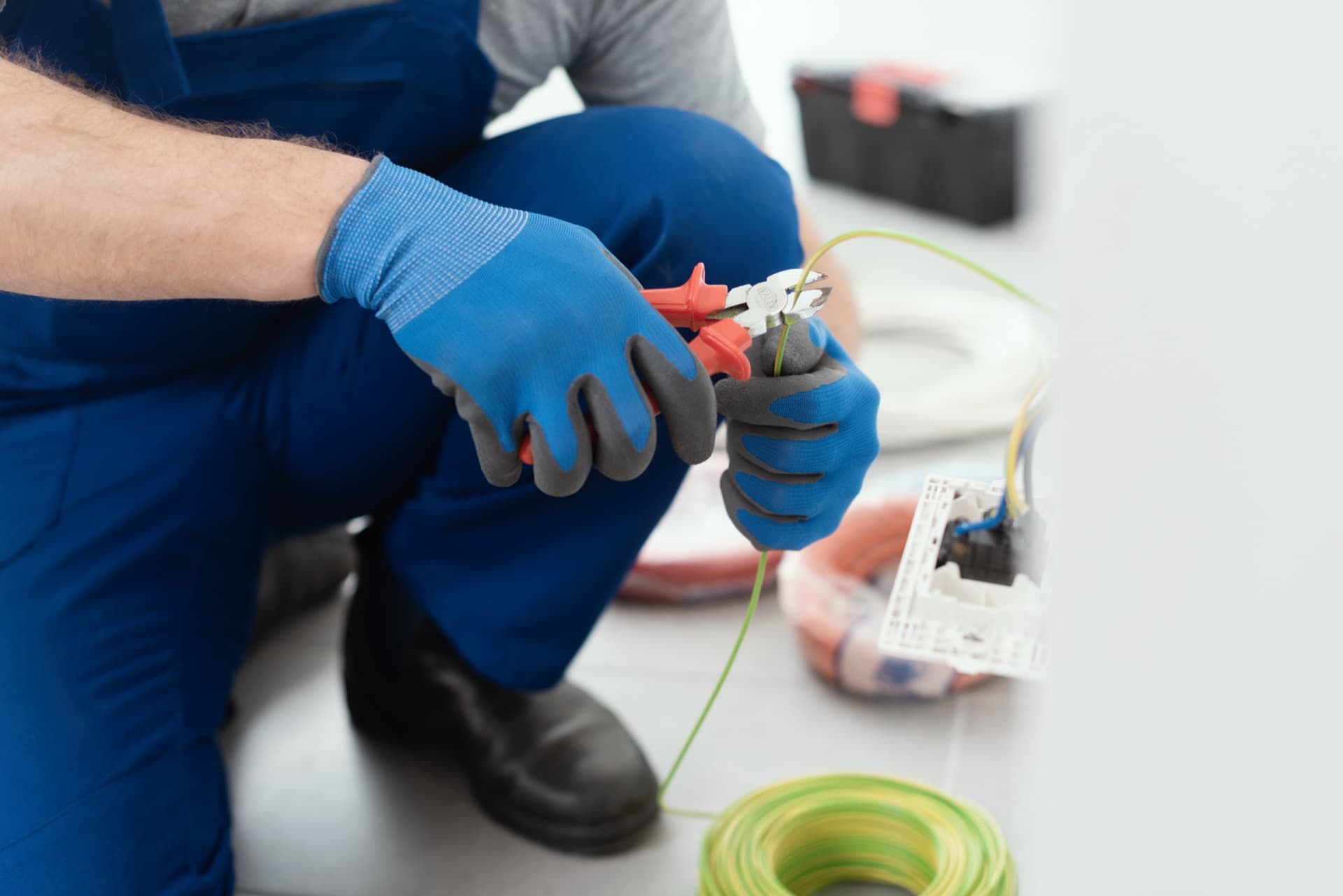 Electrician cutting wire with precision pliers