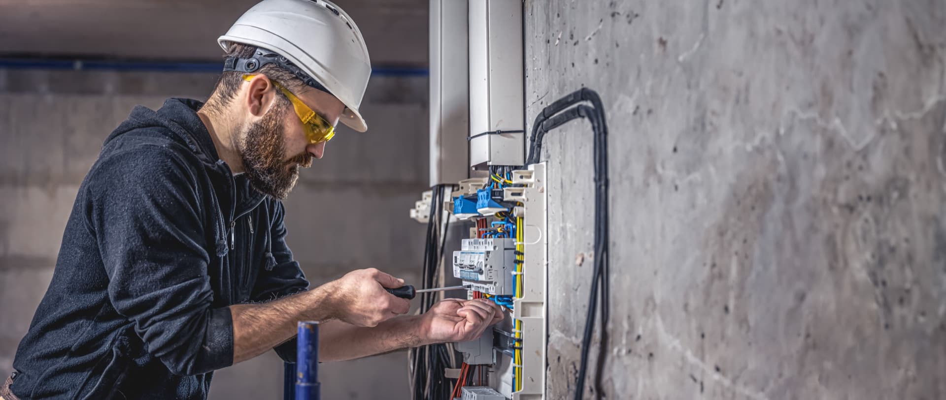Licensed electrician working on a switchboard in Massachusetts